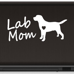 May include: White vinyl sticker with a silhouette of a Labrador Retriever and the text "Lab Mom" on a black laptop.