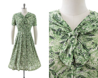 Vintage 1960s Dress | 60s Fern Leaves Green Printed Nylon Jersey Tie Neck Fit and Flare Day Dress (medium)