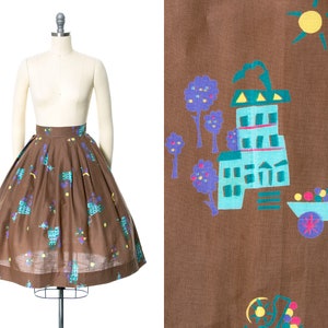 Vintage 1950s Skirt | 50s Novelty Print Cotton Floral Cart People Pleated Brown Full Swing Skirt (x-small)