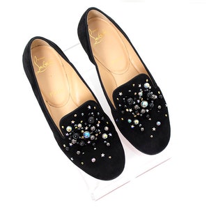 May include: Black suede loafers with a sparkly embellishment of black, silver, and iridescent beads and stars.