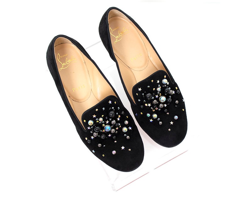 May include: Black suede loafers with a sparkly embellishment of black, silver, and iridescent beads and stars.