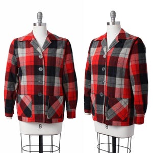 May include: A vintage red, black, and gray plaid jacket with a collared neckline, two front pockets, and button closures. The jacket is displayed on a mannequin and has a classic, timeless design. The size is 8.