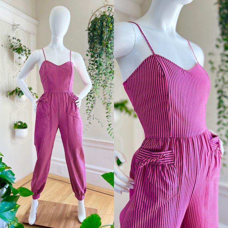 May include: A pink and black striped jumpsuit with a sweetheart neckline and pockets. The jumpsuit has a fitted bodice and wide legs.
