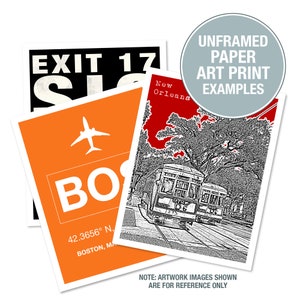 May include: Three examples of unframed paper art prints. The first print is a black and white illustration of a streetcar in New Orleans. The second print is a black and white illustration of a plane with the text "BOS" and "42.3656&deg; N. BOSTON, MA". The third print is a black and white illustration of a sign that says "EXIT 17".