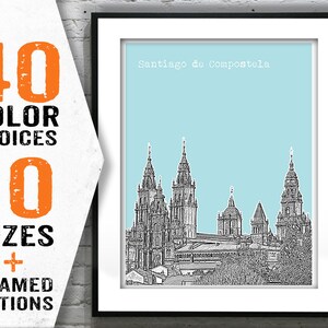 May include: A black and white illustration of the Santiago de Compostela Cathedral in Spain, with a light blue background. The illustration is framed in a black frame.