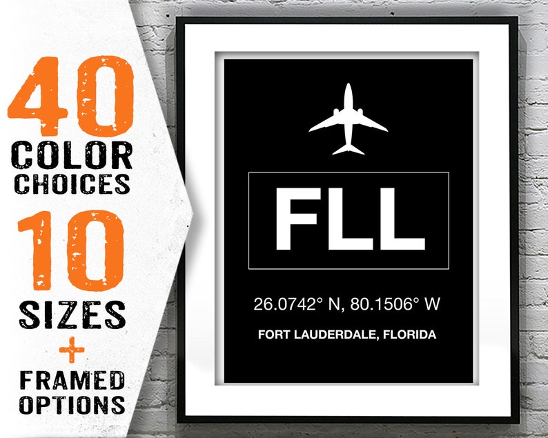 May include: A black and white airport code sign with the letters "FLL" and the coordinates "26.0742&deg; N, 80.1506&deg; W" below. The text "FORT LAUDERDALE, FLORIDA" is below the coordinates. A white airplane icon is above the code.