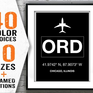 May include: Black and white airport code sign with the letters ORD, a white airplane icon, and the text "41.9742° N, 87.9073° W" and "CHICAGO, ILLINOIS".