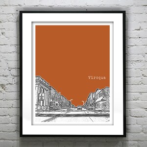 May include: A black and white illustration of a street scene in Viroqua, Wisconsin. The buildings are drawn in a simple style, and the street is empty except for a single car in the distance. The background is a solid orange color.