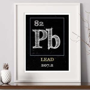 May include: A black and white illustration of the periodic table element for lead, with the atomic number 82 and atomic weight 207.2. The element symbol "Pb" is in a white box with a blue border. The word "LEAD" is written in gold below the symbol.