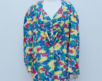 May include: A colorful blazer with a vibrant abstract pattern in yellow, blue, red, and green. The jacket features a V-neckline, long sleeves, and a button closure. The blazer is displayed on a mannequin.