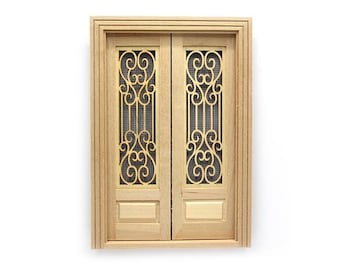 May include: A pair of wooden double doors with ornate metalwork designs. The doors are a light wood color and the metalwork is a gold color.