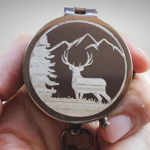 deer with mountain and trees engraved compass