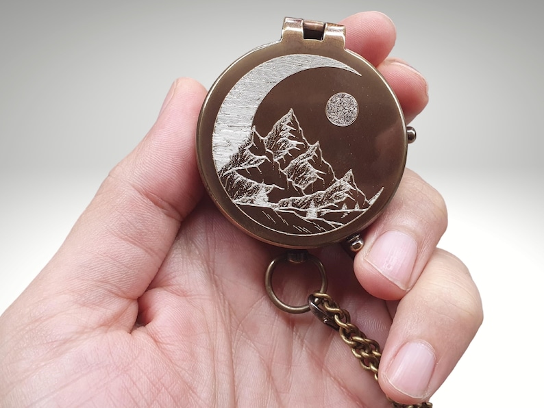 custom working compass with moon and mountains