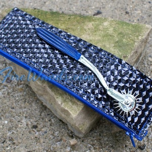 May include: A silver-colored, multi-pointed wheel tool with a blue handle, in a black and blue zippered pouch with a diamond pattern.