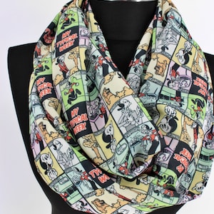 May include: A colorful infinity scarf with a cartoon design featuring Mickey Mouse and Pluto. The scarf has a repeating pattern of comic book panels with the text "My Typical Week" and the days of the week.