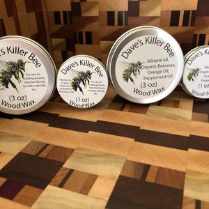May include: Three different sizes of Dave's Killer Bee wood wax. The labels are silver with black text and a bee illustration. The wax is for use on cutting boards, butcher blocks, and wooden utensils. The sizes are 1 ounce, 3 ounces, and 3 ounces.