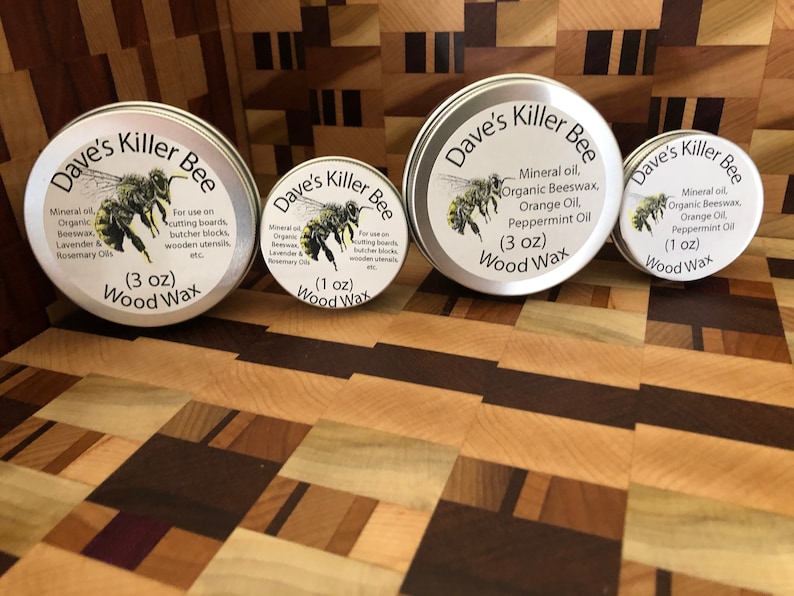 May include: Three different sizes of Dave's Killer Bee wood wax. The labels are silver with black text and a bee illustration. The wax is for use on cutting boards, butcher blocks, and wooden utensils. The sizes are 1 ounce, 3 ounces, and 3 ounces.