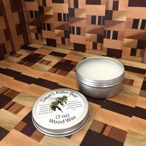 May include: A silver tin of Dave's Killer Bee Wood Wax, a 3 ounce container with a bee illustration and the text "For use on cutting boards, butcher blocks, wooden utensils, etc."