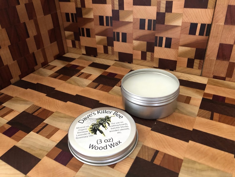 May include: A silver tin of Dave's Killer Bee Wood Wax, a 3 ounce container with a bee illustration and the text "For use on cutting boards, butcher blocks, wooden utensils, etc."