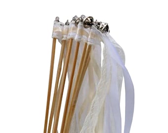 May include: A bunch of white and ivory ribbon wands with wooden sticks and silver bells. The wands are in a clear glass jar.