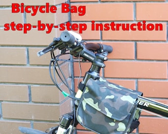 May include: A black bicycle with a camouflage-patterned bag attached to the frame. The bag is secured with straps and has a zipper closure. The bicycle has a black handlebar with a black and white logo that reads "CROSSBIKE".