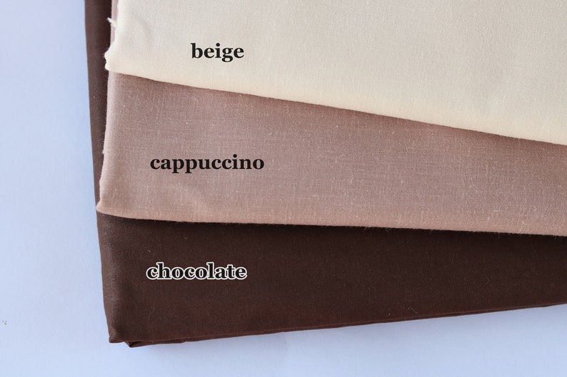 May include: Three fabric swatches in different shades of brown. The top swatch is beige, the middle swatch is cappuccino, and the bottom swatch is chocolate.