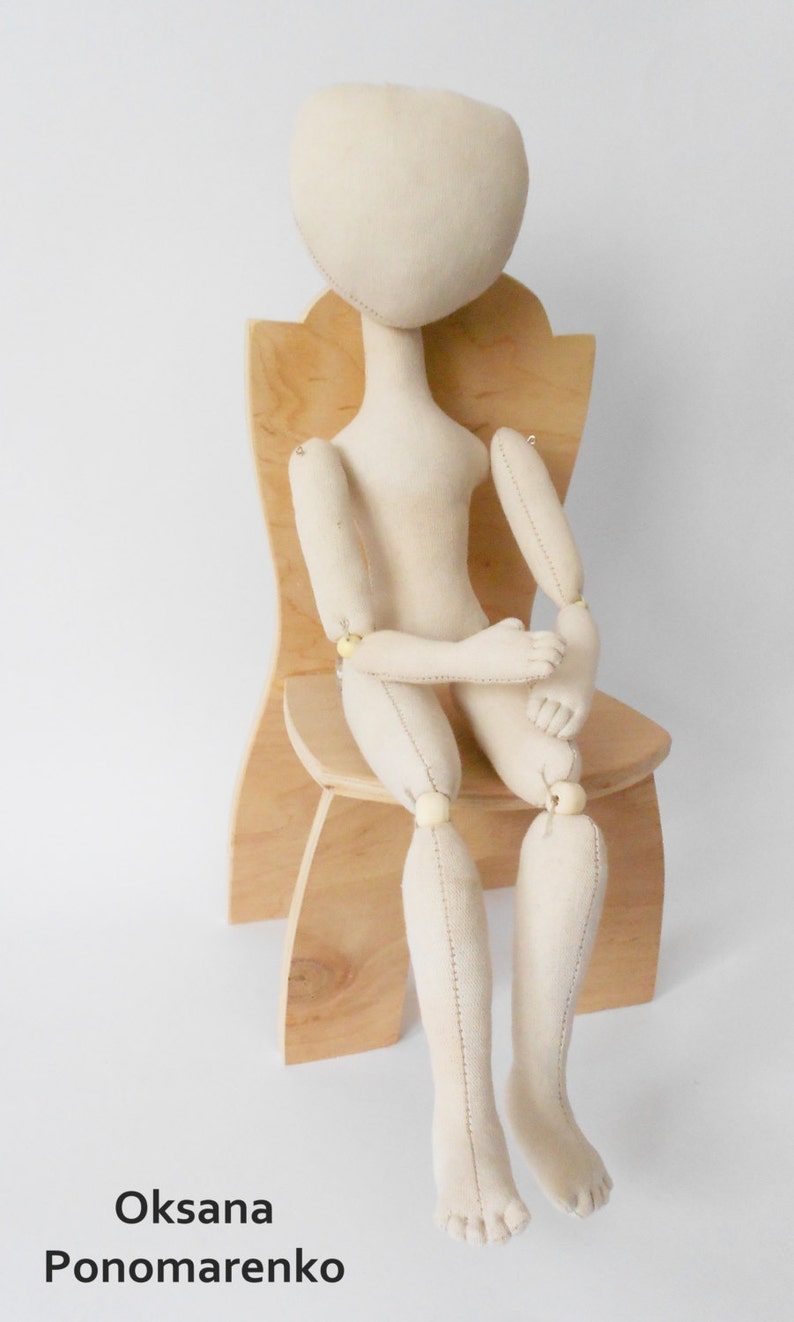 May include: A white fabric doll with jointed limbs sits on a wooden chair. The doll has a simple, unpainted face and is ready for customization.