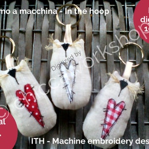 May include: Three beige fabric cat keychains with red and white hearts. The keychains are 4x4 inches and 10x10 inches. The text "Ricamo a macchina - In the hoop" and "Digital file 4x4" are visible in the image.
