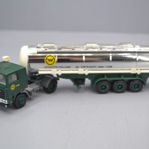 May include: A green Volvo truck with a white and silver tanker trailer. The trailer has the text "WITHOORN HOLLAND" and a logo with the letters "TW" in a yellow circle.