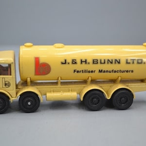 May include: A yellow toy truck with a large tank on the back. The tank has the text "J. & H. BUNN LTD. Fertiliser Manufacturers" printed on the side.