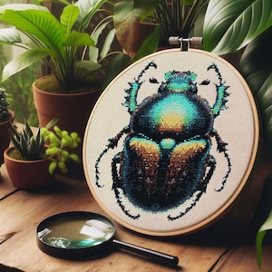May include: A close-up of a cross-stitch embroidery hoop with a detailed image of a green and blue beetle. The beetle has a shiny, iridescent exoskeleton and intricate details on its wings and legs.