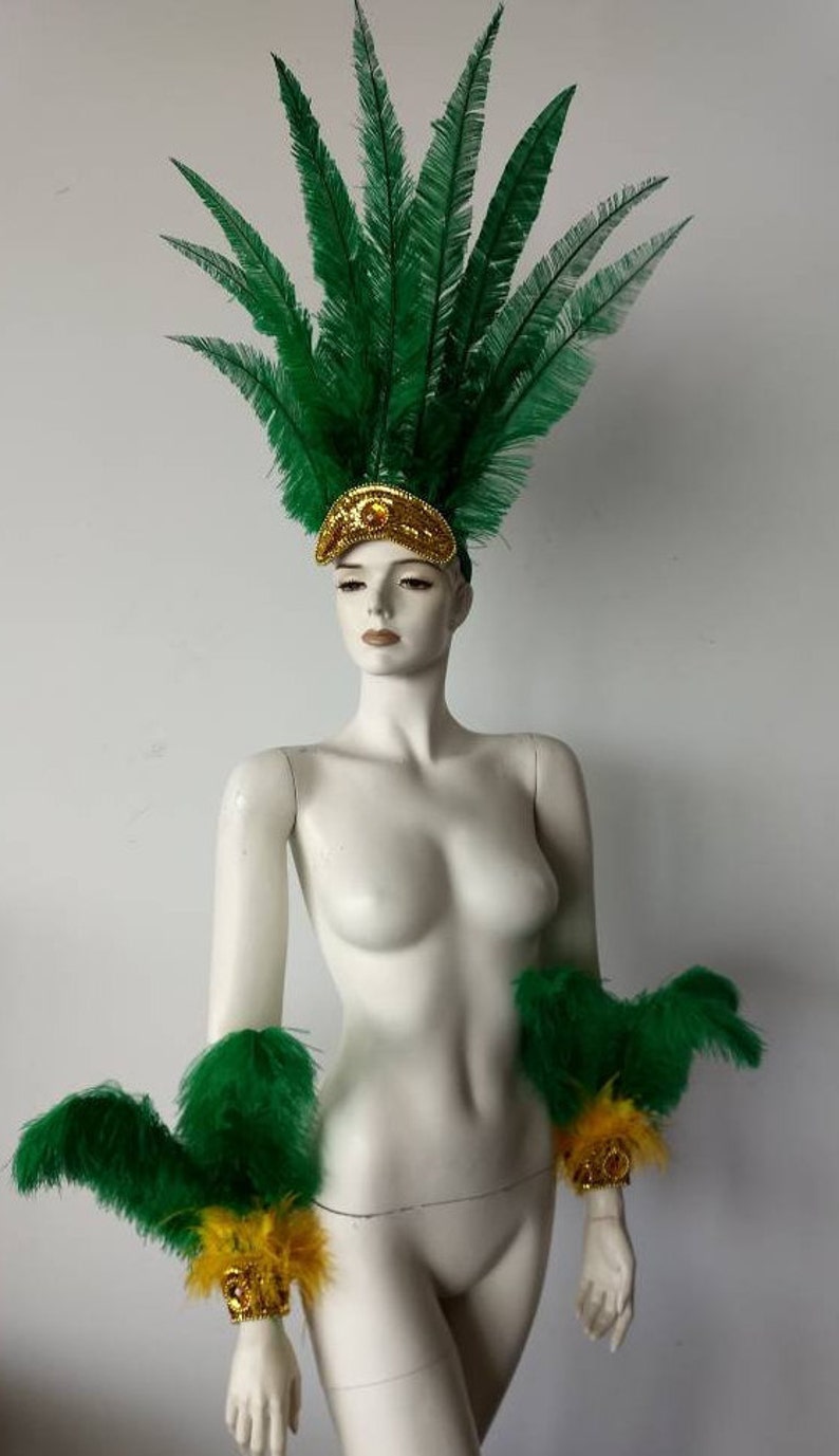 May include: Green feather headdress with gold accents and matching green feather arm cuffs with gold accents.