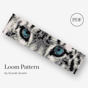 May include: A loom pattern for a beaded bracelet featuring a close-up of a white cat's eye with blue irises. The pattern is available as a PDF download. Loom Pattern by Scarab Jewels.