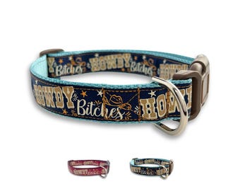 May include: A turquoise blue dog collar with a navy blue background and gold lettering that reads "Howdy Bitches". The collar has a brown buckle and a silver D-ring.