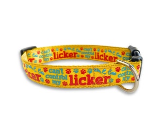 May include: Yellow dog collar with the text "Can't Control My Licker" in red and blue. The collar features paw prints and water droplet designs. It has a black plastic buckle and a silver metal D-ring.