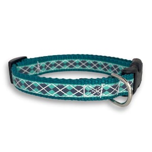 May include: Teal blue dog collar with a white and gray diamond pattern.
