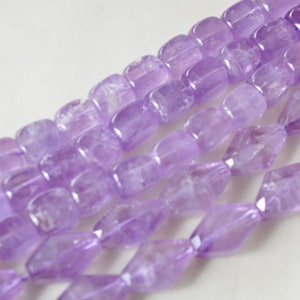 May include: A strand of light purple amethyst beads. The beads are faceted and have a rectangular shape.