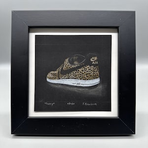 May include: A black and white drawing of a Nike Air Force 1 sneaker with a leopard print design. The drawing is framed in a black frame and includes the text "Fancy", "12/01/14", and "J. Brockett".