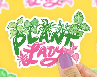 May include: A white sticker with a pink and green design. The sticker says "Plant Lady" with a variety of green plants surrounding the text.