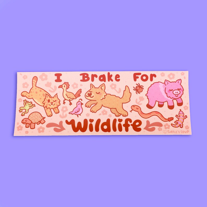 May include: A pink and orange sticker with the text "I Brake For Wildlife" and illustrations of various animals, including a cat, a bird, a wolf, a pig, a snake, a turtle, a frog, and a lizard.