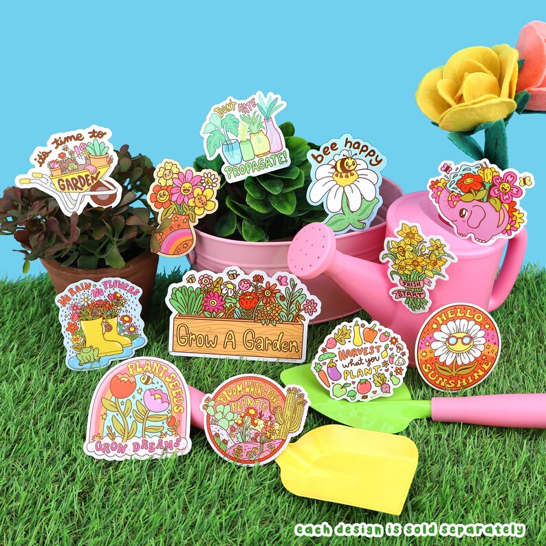 May include: A set of 10 colorful illustrated stickers with gardening themes. The stickers feature phrases like "It's time to garden", "Plant seeds", "Grow dreams", "Bee happy", "Don't hate propagate", "Harvest what you plant", "Bloom where you're planted", "No rain, no flowers", "Hello sunshine", and "Grow a garden".