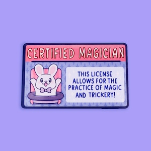 May include: A pink and blue card with the text "CERTIFIED MAGICIAN" and a cartoon rabbit in a top hat. The text below the rabbit says "THIS LICENSE ALLOWS FOR THE PRACTICE OF MAGIC AND TRICKERY!"