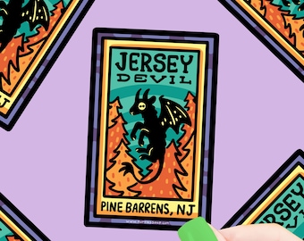 May include: A sticker featuring a black silhouette of the Jersey Devil, a mythical creature with wings and horns, against a green background with orange trees. The sticker reads "Jersey Devil" and "Pine Barrens, NJ".