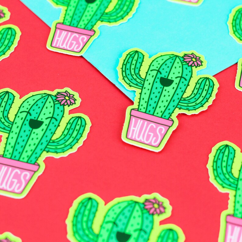 May include: A set of green cactus stickers with a pink pot and a pink flower on top. The pot has the word "HUGS" written on it.