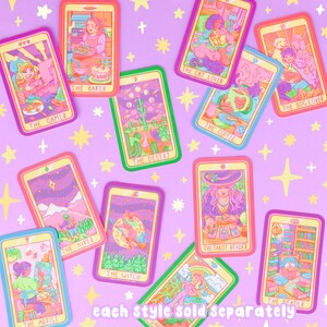 May include: A set of colorful illustrated cards with a variety of themes, including a gamer, a baker, a hiker, a desert, a cat lover, a coffee drinker, a tarot reader, a dog lover, an artist, a witch, and a reader. Each card has a unique design and features a different character or scene. The text on the cards reads "The Gamer", "The Baker", "The Hiker", "The Desert", "The Cat Lover", "The Coffee", "The Tarot Reader", "The Dog Lover", "The Artist", "The Witch", and "The Reader".