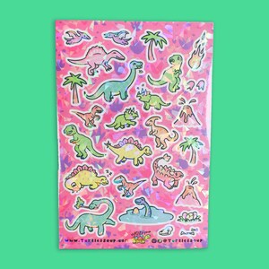 May include: A sheet of holographic pink stickers featuring various cartoon dinosaurs, including a stegosaurus, a brachiosaurus, a triceratops, and a tyrannosaurus rex. The stickers also include palm trees, volcanoes, and a bone. The text "www.TurtlesSoup.com @TurtlesSoup" is at the bottom of the sheet.