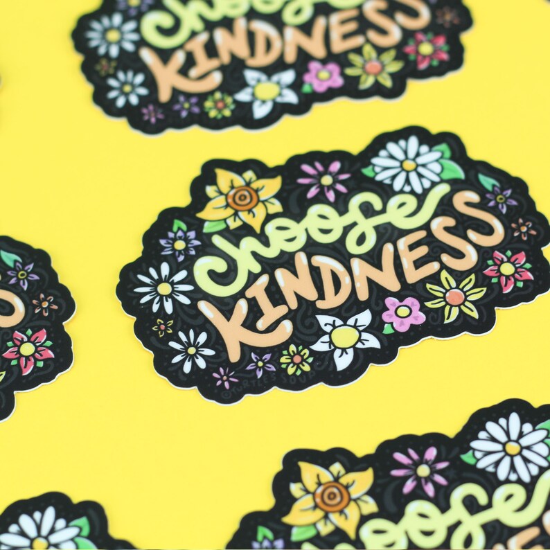 May include: Black and white sticker with the text "Choose Kindness" in yellow and orange lettering. The sticker is surrounded by a border of colourful flowers.