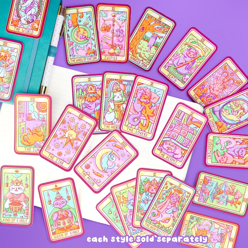 May include: A set of colorful tarot cards featuring cats in various poses. Each card has a red border and a yellow background with a pink and blue design. The cards are labeled with the names of the tarot cards, such as "The World", "The Wheel of Fortune", and "Justice".