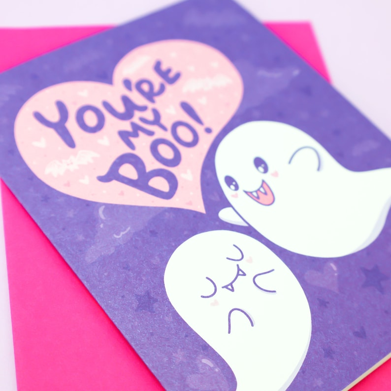 May include: A purple card with a pink heart that says "You're my Boo!" with two white ghosts on a purple background.