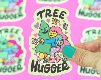 May include: A green tree with a smiling face is being hugged by a person with pink hair. The person is wearing a blue jacket and a white skirt with pink flowers. The sticker says "Tree Hugger" in large letters.